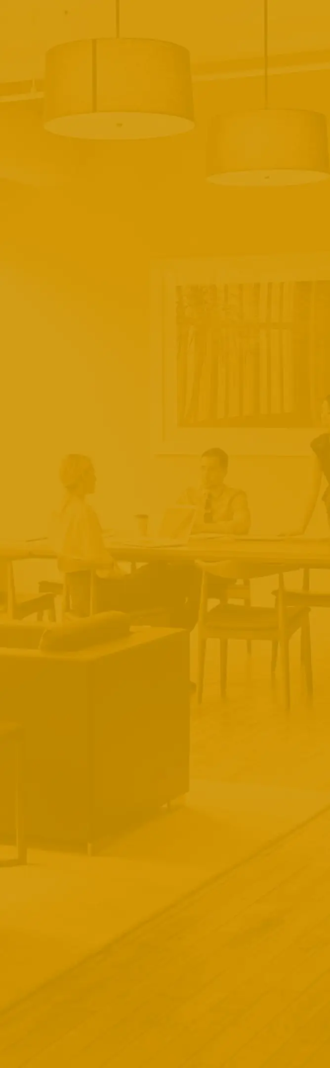 A busy office with people working at their desks and moving around the office